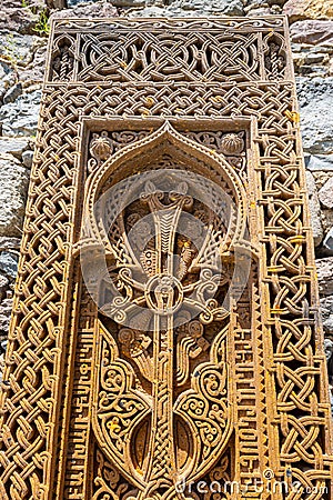 Traditional carved khachkar or cross-stone near Geghard Cathedral, close-up view. Armenian heritage and Art Editorial Stock Photo