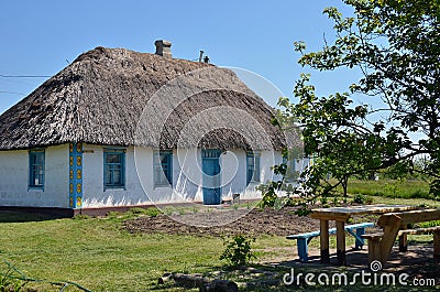 Ancient traditional ukrainian rural cottage with a straw roof, Ukraine Stock Photo