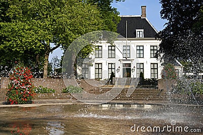 Ancient village hall and fountain in park, Hillegom Stock Photo