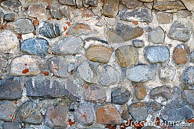 The image of an ancient wall of boulders and bricks as the background Stock Photo
