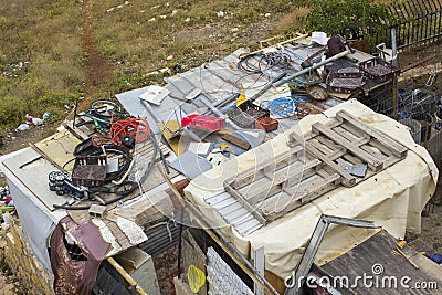 Ancient Waste thoughtlessly piled upon rooftops of Arab homes in the city Editorial Stock Photo