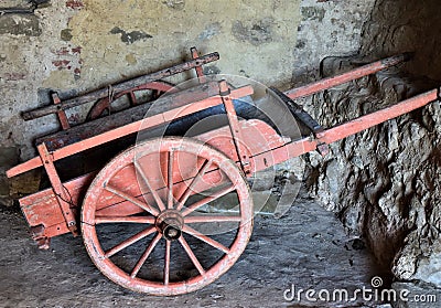 Ancient wooden cart, in a passage, in Ghivizzano in the province of Lucca, one of the beautiful and ancient medieval villages exis Stock Photo