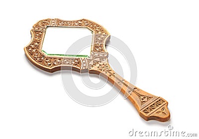 Ancient wooden hand mirror lies on a white background Stock Photo