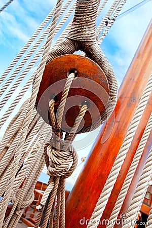 Ancient wooden sailboat pulleys and ropes Stock Photo