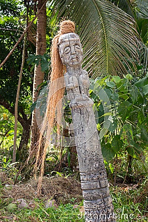 Ancient wooden statue in jungle. Old religious totem. Shaman column in temple, Asia. Traditional shaman symbol. Stock Photo