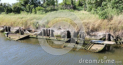 Wreck of a sunken wooden boat in the lagoon water Stock Photo