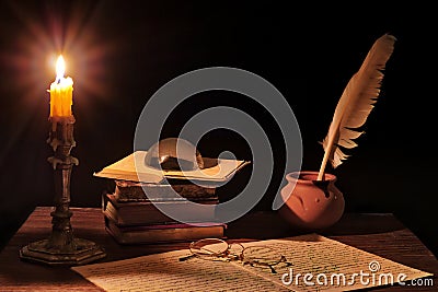 Ancient writer`s working desk with candlestick Stock Photo