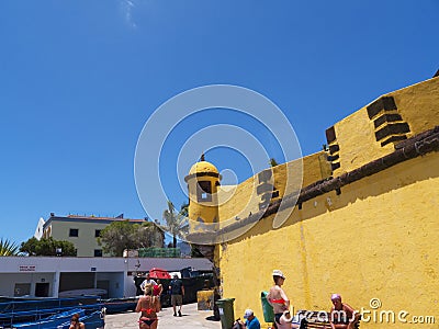 The ancient yellow Fortress of Sao Tiago with its bathing platforms into the Atlantic Ocean Editorial Stock Photo