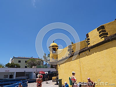 The ancient yellow Fortress of Sao Tiago with its bathing platforms into the Atlantic Ocean Editorial Stock Photo