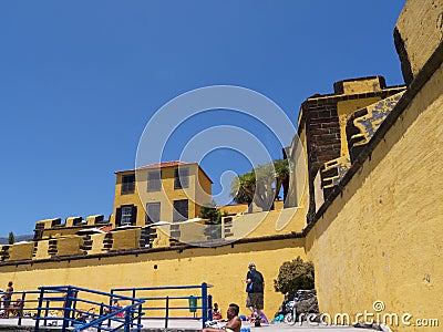 The ancient yellow Fortress of Sao Tiago with its bathing platforms into the Atlantic Ocean Editorial Stock Photo