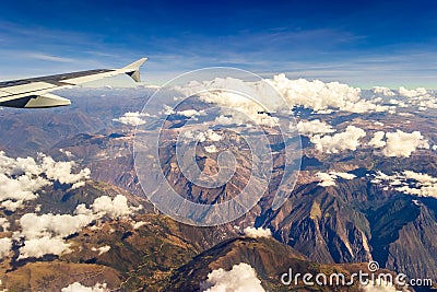 Andes Mountains, Peru - Airplane Wing Window View on Flight over the Colorful Andes Mountains in Peru Stock Photo