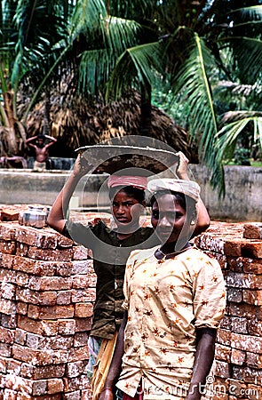 Andhra Pradesh, India, circa August 2002: Female workers carry bricks Editorial Stock Photo
