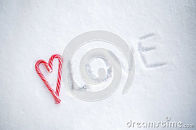 Ð¡andies in heart shape on a background of snow Stock Photo