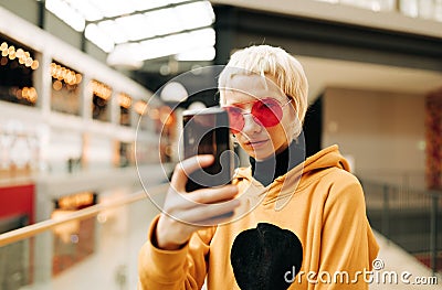 Androgyne Woman making selfie indoors Stock Photo