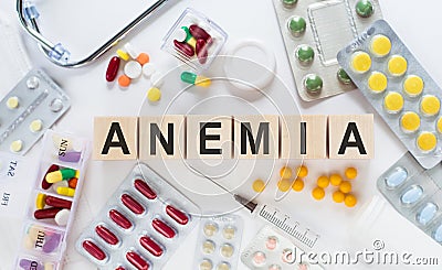 ANEMIA word written on building blocks. Pills and stethoscope background. Medical concept Stock Photo