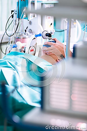Anesthesia - patient under narcosis, breathing through a mask Stock Photo