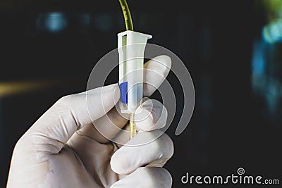 Anesthesiologist Doctors is adjusting extension tube control of saline solution mixed drug. Stock Photo