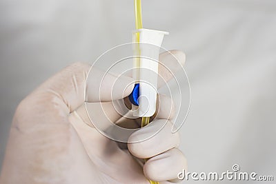 Anesthesiologist Doctors is adjusting extension tube control of saline solution mixed drug. Stock Photo