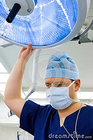 Anesthesiologist with surgical lamp Stock Photo