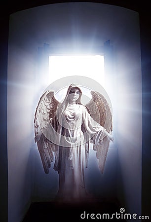 Angel archangel standing in mystic gate with divine rays of light like spiritual and religious concept Stock Photo