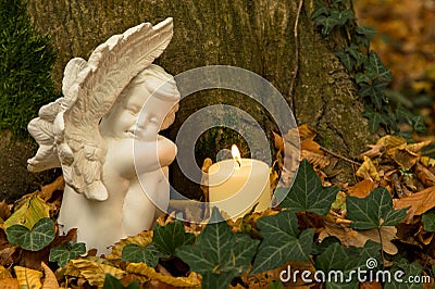 Angel with candle, nature cemetery Stock Photo