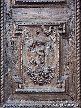 Angel carved on the wooden portal of an ancient Italian church Stock Photo