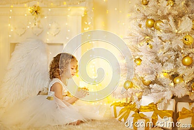 Angel Child and Christmas Tree with Presents Gifts, Kid Girl Stock Photo