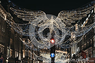 Angel Christmas lights and decorations on Regent Street in the evening, London, UK Editorial Stock Photo