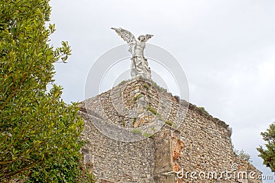 Angel of death in Comillas cemetery in Spain Stock Photo