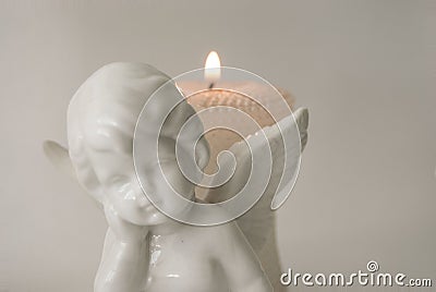 Angel figure with burning candles Stock Photo