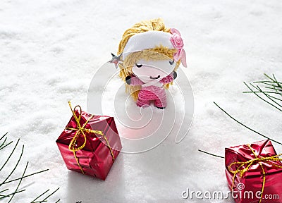 Angel and gift on snow, doll hand made concept Stock Photo