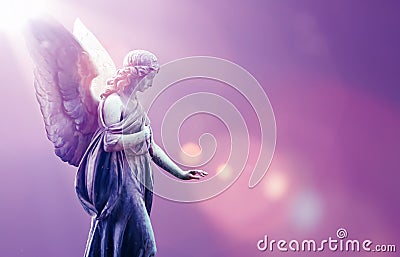 Angel in heaven over purple sky background Stock Photo