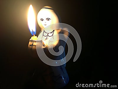 An angel holding a candle Stock Photo