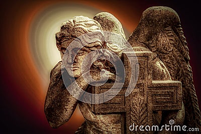 Angel holy being sad at the grave in a mystical background Stock Photo