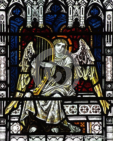 Angel making music ( playing harp)in stained glass Stock Photo