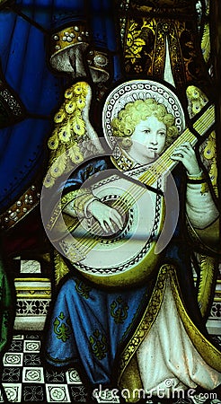 Angel making music in stained glass Stock Photo