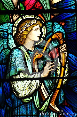 An angel making music in stained glass Stock Photo