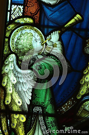 Angel making music with a trumpet (stained glass) Stock Photo