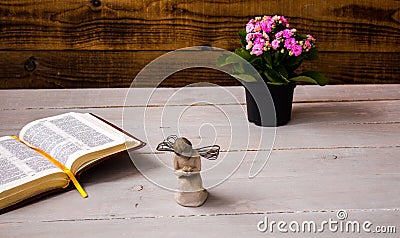 Angel and the open bible and flowers Stock Photo