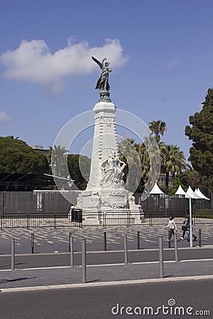 Angel statue in Nice, with two people walking near it Editorial Stock Photo