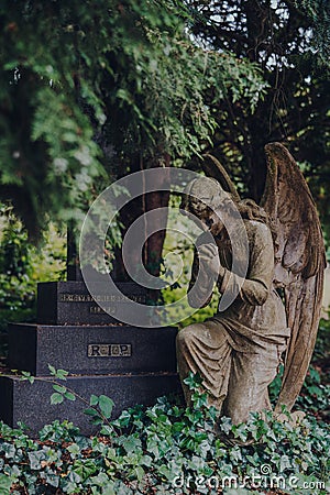 Angel statue by a tomb inside Hampstead Cemetery, London, UK Editorial Stock Photo