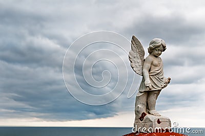 Angel under storm clouds Stock Photo