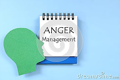 Anger management concept. Human head profile beside a notepad with written text. Stock Photo