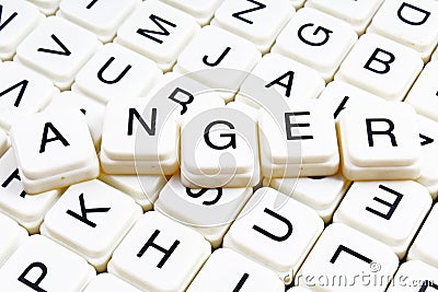 Anger text word crossword title caption label cover background. Alphabet letter toy blocks. White alphabetical letters. Stock Photo