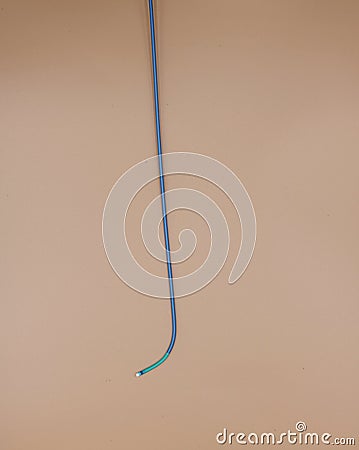 Angioplasty guiding catheter used to treat blockage in the arteries of heart . Image isolated on beige background Stock Photo