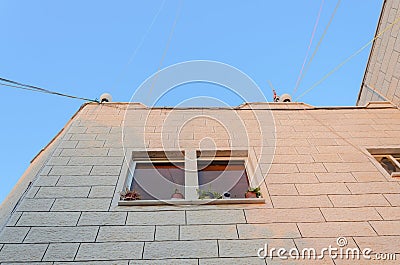 The angle of a new residential building with a window on a blue sky background Stock Photo