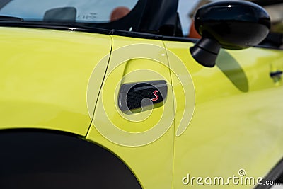 Angle view on brand mark letter S on side of new shiny sports automobile Mini Cooper Cabriolet parked outside on sunny Editorial Stock Photo