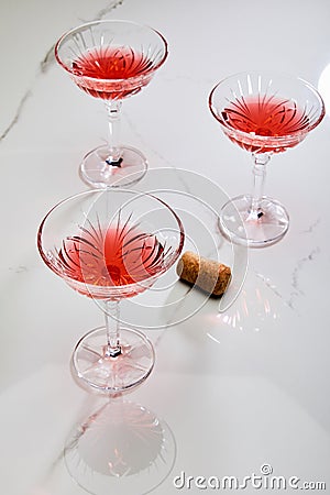 Angle view of glasses of cocktail near cork on white background Stock Photo