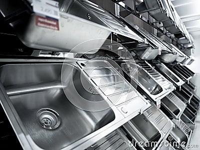 Angle view of rows metal kitchen sink at the showroom of a large store. Stock Photo