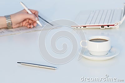 Angle View of Work Place with Laptop Color Pencils and Business Newspaper Stock Photo